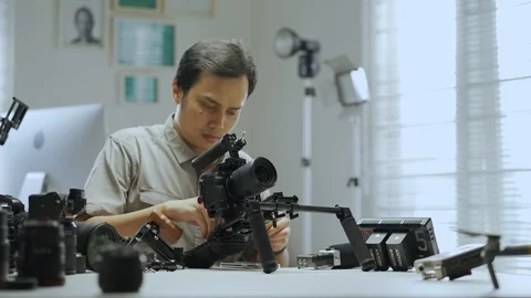 An Asian man is setting up a camera rig  Video stock 128406753