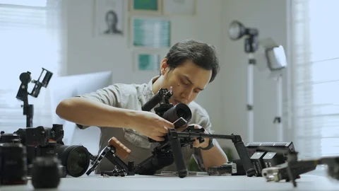 An Asian man is setting a camera rig Video stock 128406878