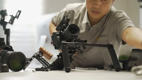 An Asian man is setting a camera rig Video stock 128407039