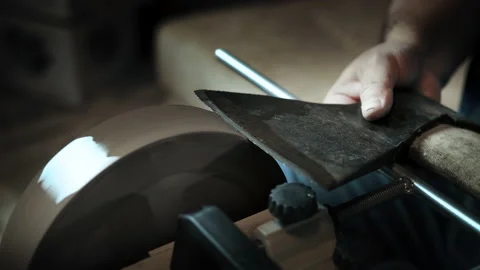 Asian man sharpening axe on a grinder Video stock 143673244