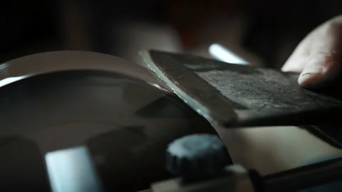 Asian man sharpening axe on a grinder. Macro shoot Stock Footage 143673345
