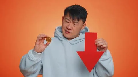 Asian man show bitcoins BTC, down sign decrease of exchange rate fall of stock 스톡 사진