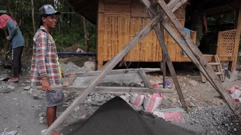 Asian Man sifting sand Stock Footage 165291313