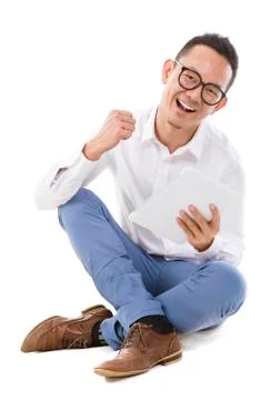 Asian man sitting on floor using tablet Stock Photos