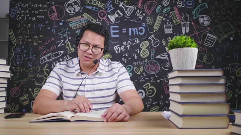Asian man sitting on the table and trying to record a video for teaching Stock Footage 172051681