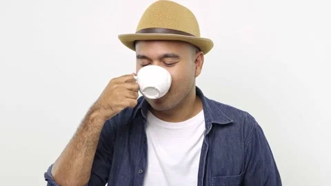  Asian man smelling and drinking coffee. A young man tasting a cup of favorite h Stock Footage 144652175