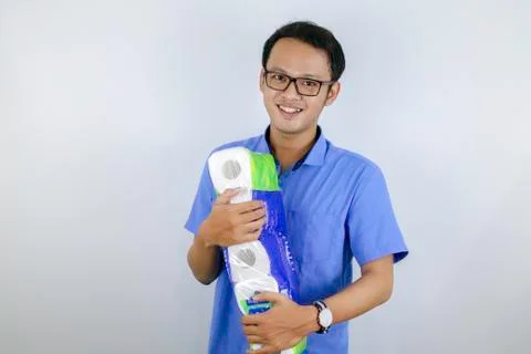 Asian Man is smile and happy when shopping bag with tissue toilet paper rolls Stock Photos