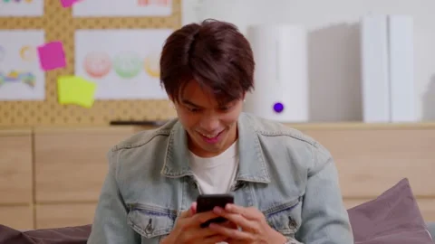 Asian man is smiling and expressing his happy feeling on the cellphone screen Stock Footage 172254271