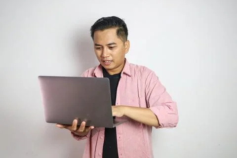 Asian man smiling happy while working using his laptop Stock Photos