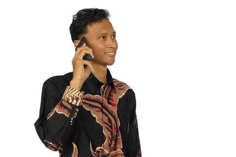 Asian man smiling while making a phone call Stock Photos