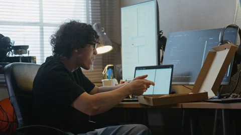 Asian Man Software Developer Eating Pizza, Texting on Phone at Desk Stock Footage 338423698