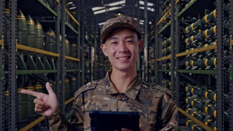 Asian Man Soldier Using A Tablet And Pointing To Side In Military Storage Stock Footage 313738083