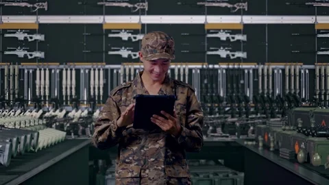 Asian Man Soldier Using A Tablet In Military Armory Stock Footage 313739512