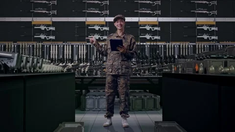 Asian Man Soldier Using A Tablet And Pointing To Side In Military Armory Stock Footage 313740624