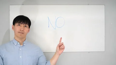 Asian man standing in front of a white board writing yes no or mabye Vidéo 263858698