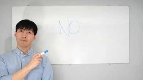 Asian man standing in front of a white board writing yes no or mabye Vidéo 263858703