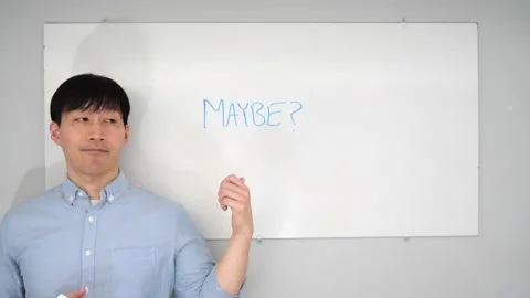 Asian man standing in front of a white board writing yes no or mabye Vidéo 263858751