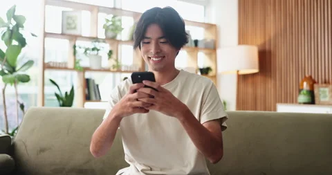 Asian man, student and reading with phone in house for education results, Stock Footage 327345552