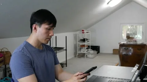 Asian man taking a rest break and using his cell phone Stock-Footage 247874224