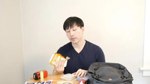 Asian man talking about rations and MRE for emergency preperations Stock Footage 248869006