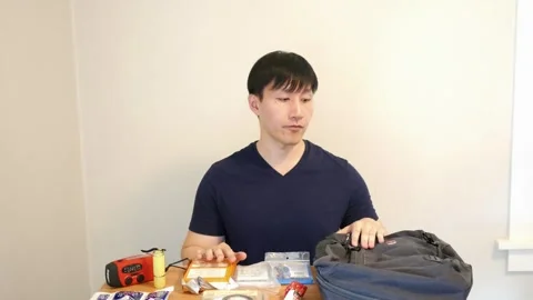 Asian man talking to camera about safety prepration for the doomsday Stock Footage 248869039