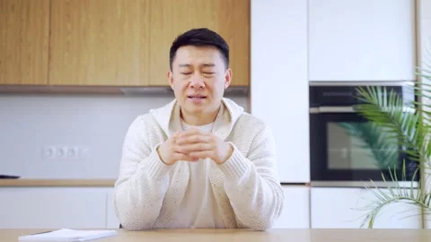Asian man talking online on video call at home in living room or kitchen. male  Stock Footage 155315030
