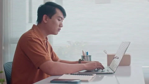 Asian Man Testing Code on Wireless Laptop Stock Footage 265067959