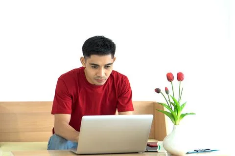 Asian man thinking serious working on laptop at home  office Foto stock
