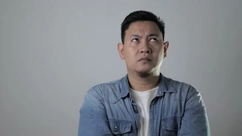 Asian man thinking something seriously, sad worried contemplation gesture Stock Footage 143517572