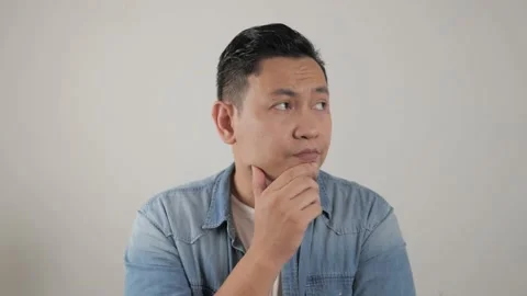 Asian man thinking something seriously, sad worried contemplation gesture Stock Footage 143773482