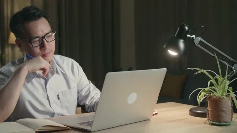 Asian Man Thinking While Working From Home At Living Room At Night Stock Footage 154917628