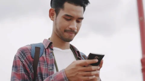 Asian  man tourist using  smart phone at Tourist attraction in Bangkok city Stock Footage 118836951