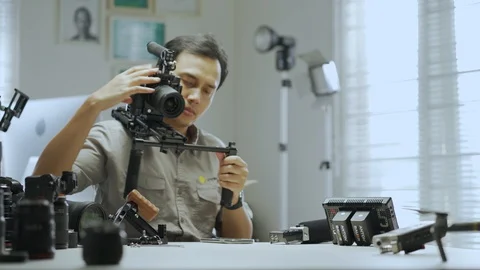 An Asian man is trying a camera rig  Video stock 128406895