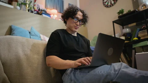 Asian Man Typing on Laptop Computer during Remote Work at Home Stock Footage 338422518