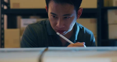 Asian man use digital tablet online check stock cardboard box in shelf. Video stock 203411402