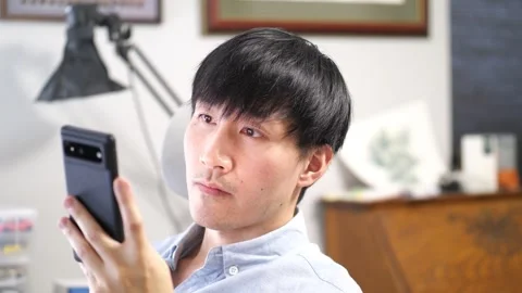 Asian man using a cellphone Stock Footage 280143240
