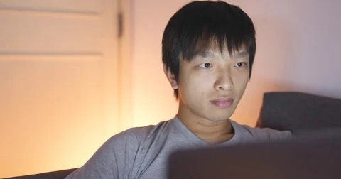 Asian man using computer at home Stock Footage 81151154
