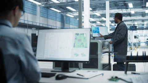 Asian Man Using Computer With Microchip Design At Factory Stock Footage 260479747