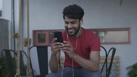 Asian man using digital display touchscreen smart phone device at home screen Vídeo Stock 154036713