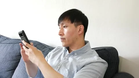 Asian man using his cellphone for work and casual time Stock-Footage 247480030