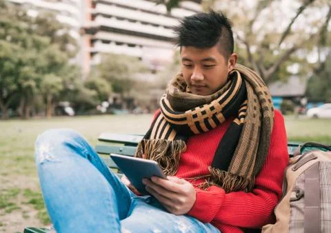 Asian man using his digital tablet. Stock Photos