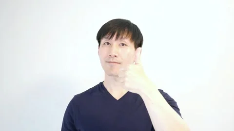 Asian man with using his left hand to gives a thumbs up Stock Footage 248869503