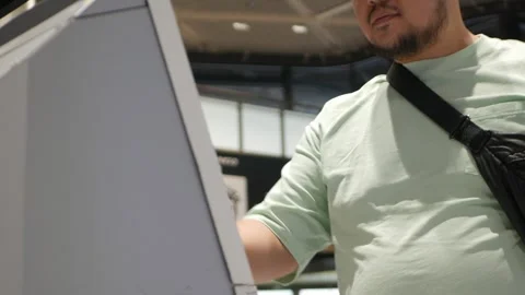 An asian man using Kiosk self check in machine at departure airport termina.. Stock Footage 313429999