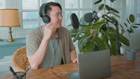 An asian man is using microphone podcasting in home Stock Footage 172008286