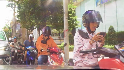 Asian man using mobile phone while waiting for traffic light Stock Footage 113441244