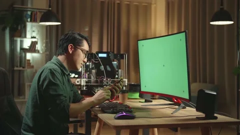 Asian Man Using Mobile Phone While Work On 3D Printer And Personal Computer Stock Footage 158108668