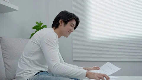 Asian man using a mobile phone scan QR code for pay. Handsome men use technol Stock Footage 217953886