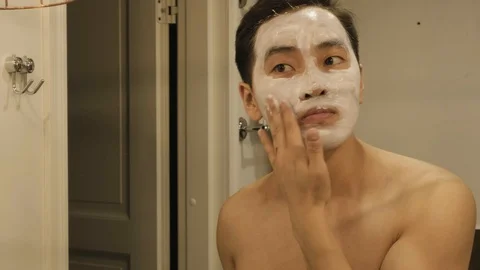 Asian Man Using A Natural Clay Facial Mask Stock Footage 130003695