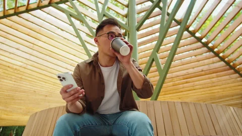 Asian man using phone outdoor close-up. Korean young guy freelancer working Stock Footage 220201028