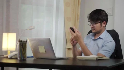 Asian man using phone  working and  Laptop ,Email concept. Stock Footage 244799214